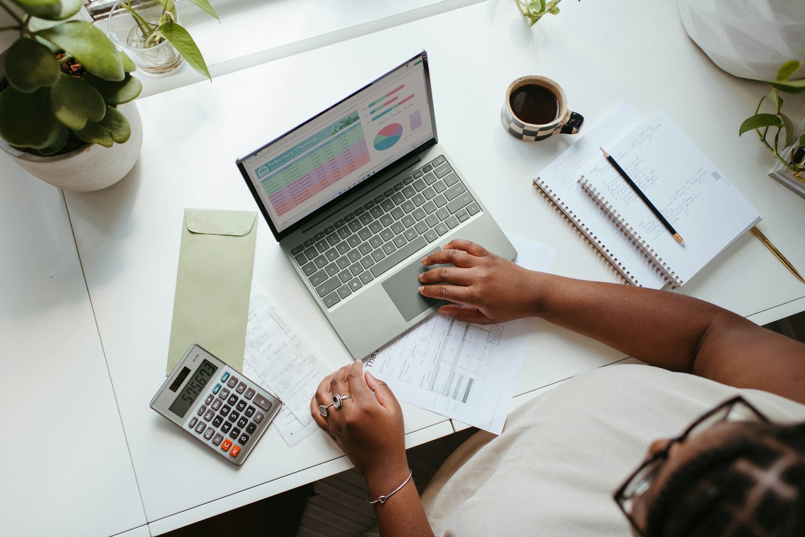 Calculator and notebook on a desk, representing student budgeting